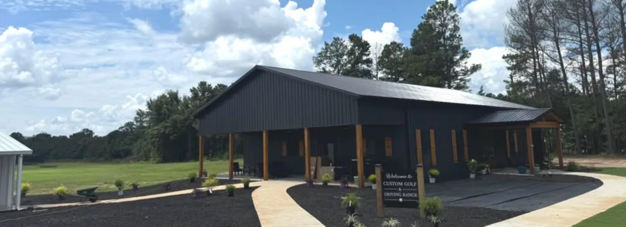 Driving range building with a covered porch and grass practice area